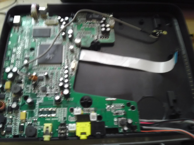The opened DVD player with no DVD carriage.